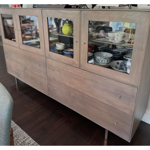 Beautiful Hudson buffet storage cabinet with steel base. Wood maple with shell stain, stainless steel base and stainless...