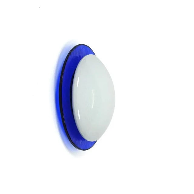 Fantastic mouth-blown round wall or ceiling sconce in embossed blue and white murano glass. This magnificent light was...