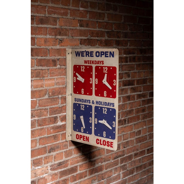 Double-sided painted metal shop sign featuring bold "WE'RE OPEN" header in blue with contrasting red "WEEKDAYS" and blue...