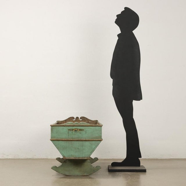 Cradle in lacquered poplar wood, 20th century Italy. Adorned with golden moldings and painted floral elements....