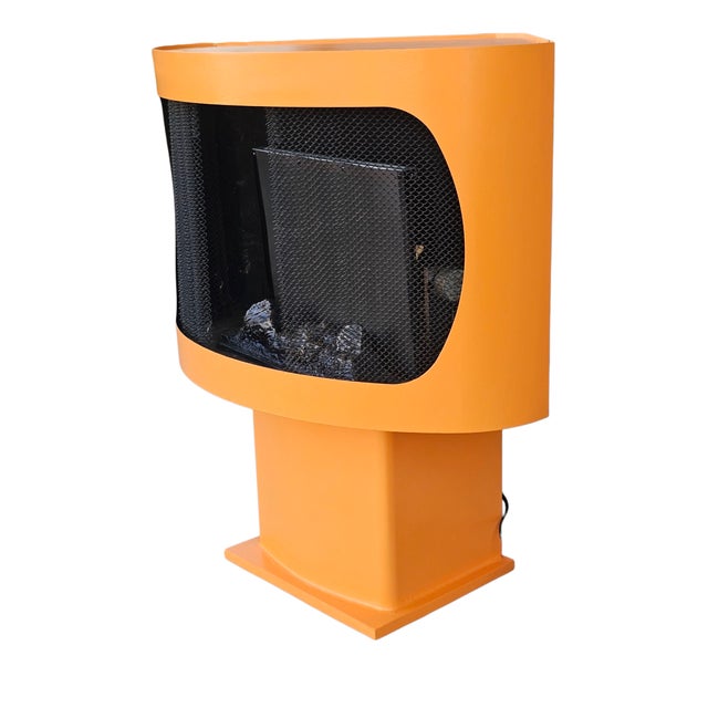 A fun, tangerine colored, electric fireplace from the mid 20th century. This Mid Century Modern free-standing corner unit...