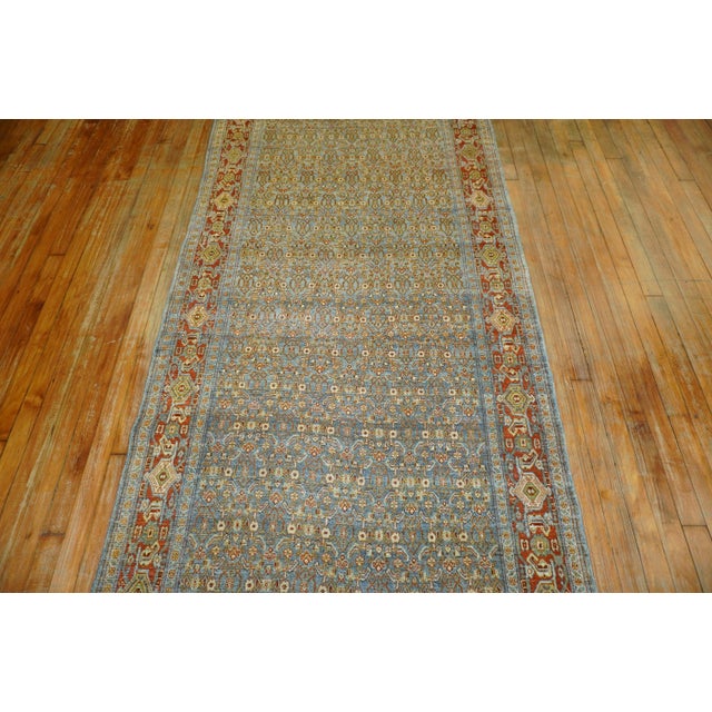Fine quality slate blue field, red border Persian Senneh Runner. It has that repetitive Classic Herati design you see in...