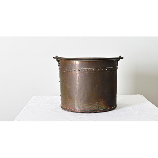 An antique French copper cooking pot with handle for suspending over the fire, dating to the second half of the 19th...