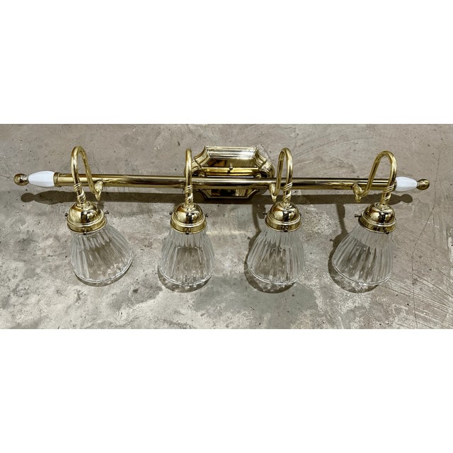 34” wide 10” tall Good condition This fixture features a bright, polished brass that perfectly complements traditional or...