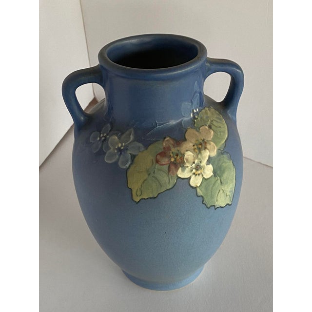 Antique Arts & Crafts art pottery vase by Weller Pottery features pink and white floral design on graduated sea foam green...