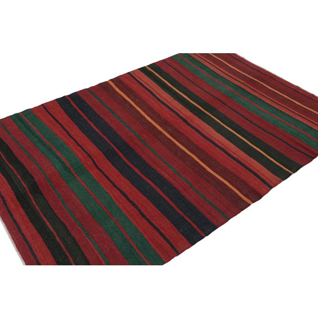 This vintage 7x11 Persian Kilim is believed to be a tribal rug of Karadagh—a mountainous region known for its craft....