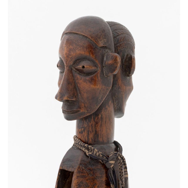African Yaka Double-Headed Slit Drum, Democratic Republic of the Congo, hand-carved wood with textile around neck, paper...