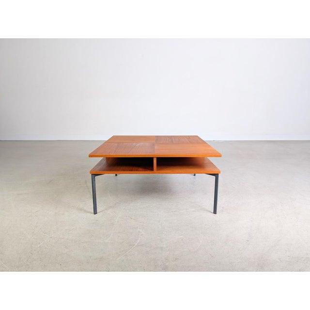 We are offering a very rare vintage teak coffee table from the 1970s for sale. The table is square and features a shelf...
