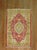 A mid 20th century Turkish rug with a colorful red and green palette Measures: 2'10'' x 4'1''.