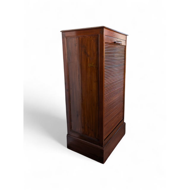 This elegant solid wood rolling shutter filing cabinet, dating back to the first half of the 20th century, is a perfect...
