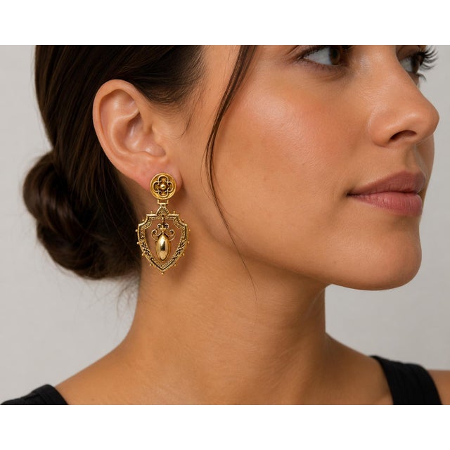 14k Edwardian Period Earrings. Ornate shield design with central drop motif. Total weight 10.88 g.