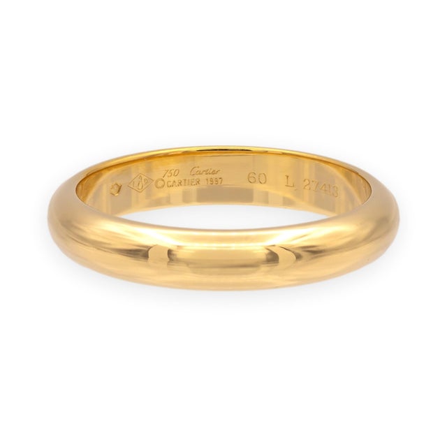 A classic wedding band from Cartier's 1895 collection. The 4mm rounded profile in 18k yellow gold sits comfortably on the...