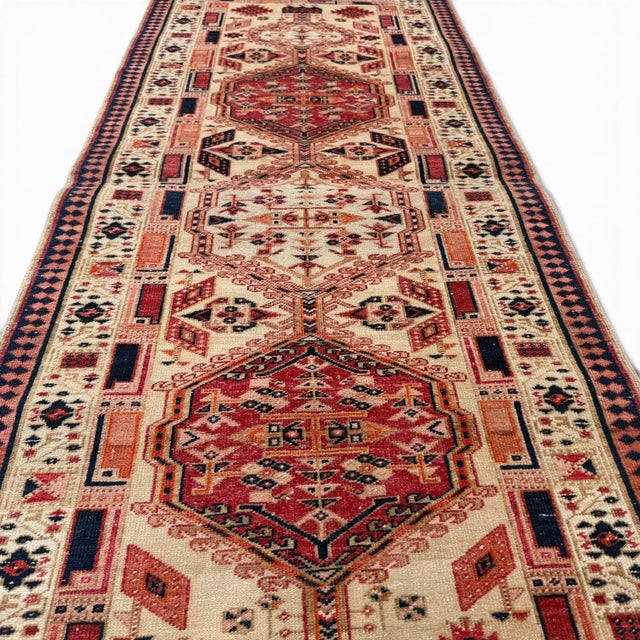This antique runner, approximately 100 years old, features a distinctive medallion design inspired by the geometric...