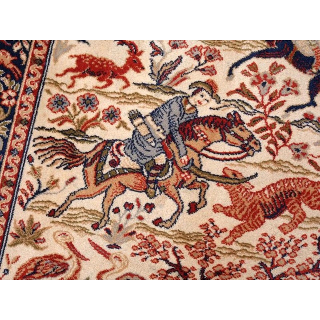 A decorative smaller rug with a traditional hunting motif, based on originals known from Isfahan workshops. This type of...
