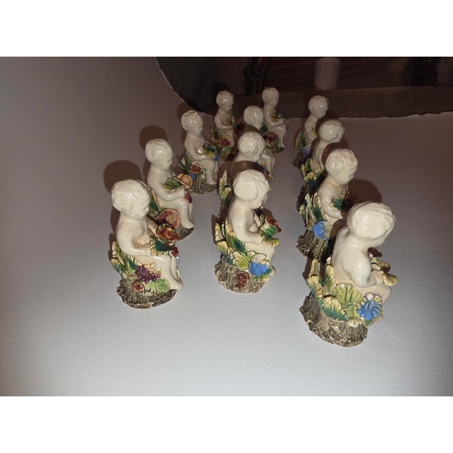 Beautiful little capodimonte ceramic figural place card holders..set of twelve.