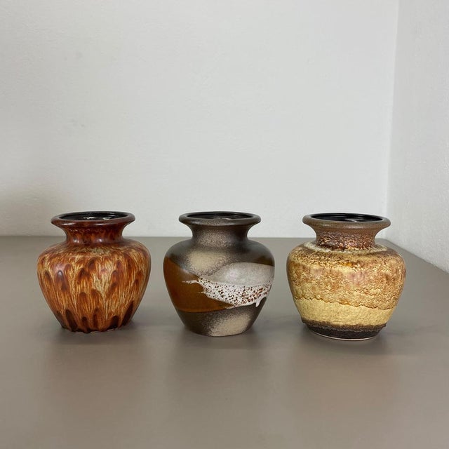 Article: Set of three fat lava art vases. Producer: Scheurich, Germany. Decade: 1970s. These original vintage vases was...