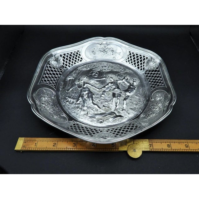 This antique German or Continental silver serving tray or plate boasts intricate reticulated patterns around the rim and...