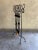 Black, hand forged, wrought iron fireplace tool set. It includes a stand with a decorative, scrollwork design and four...