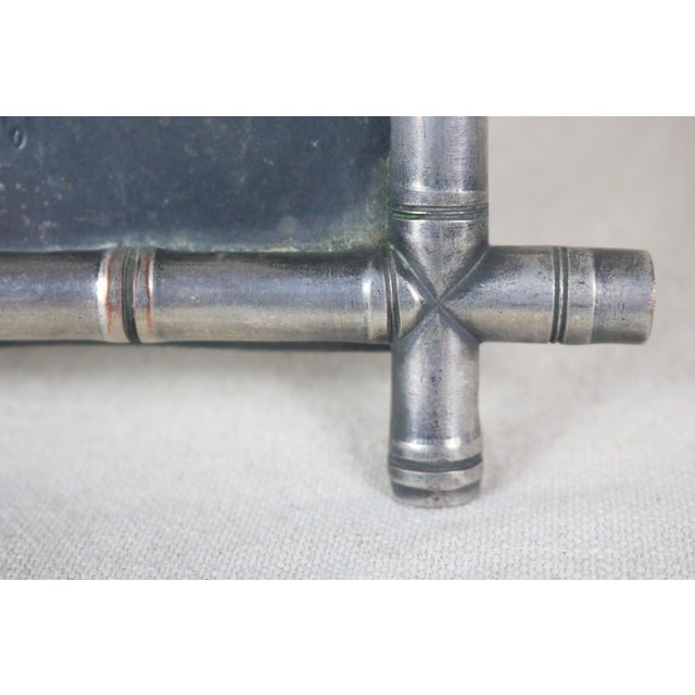 An iron photo frame with a faux bamboo design dating from the Napoleon III period in France (late 19th century). The frame...