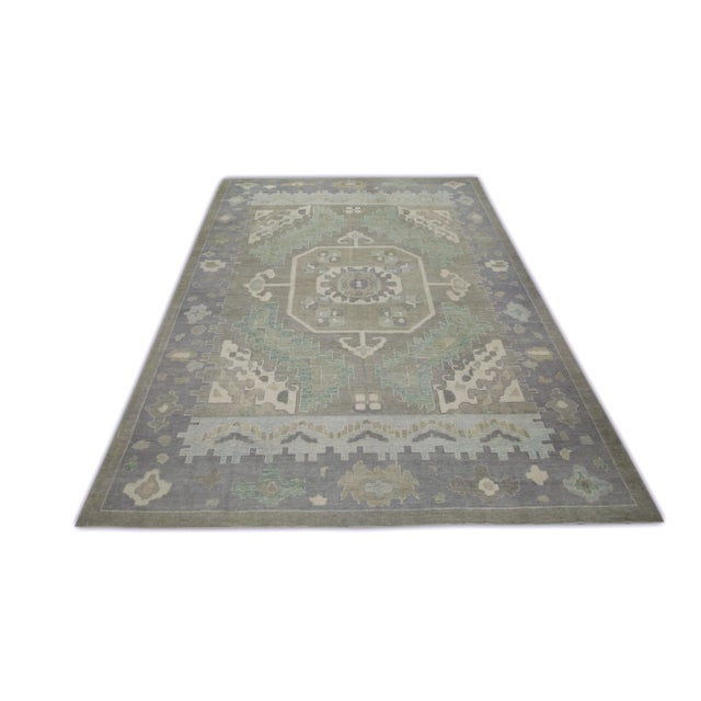 This modern Turkish Oushak rug is a stunning piece of art that has been handwoven using traditional techniques by skilled...