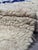 Vintage Boujad Rug | Handwoven Berber Wool Rug with Camel Field and Zigzag Diamond Motifs This striking vintage Boujad rug...