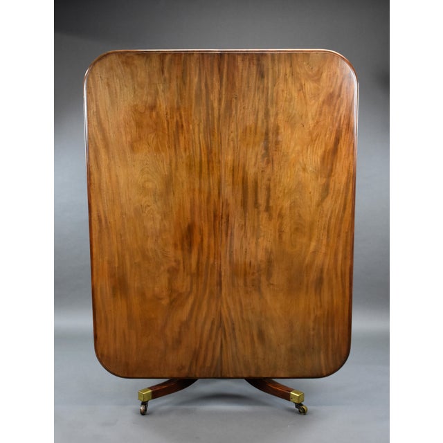 A good quality Regency mahogany breakfast table, the solid and well figured top, above a carved stem, standing on four...