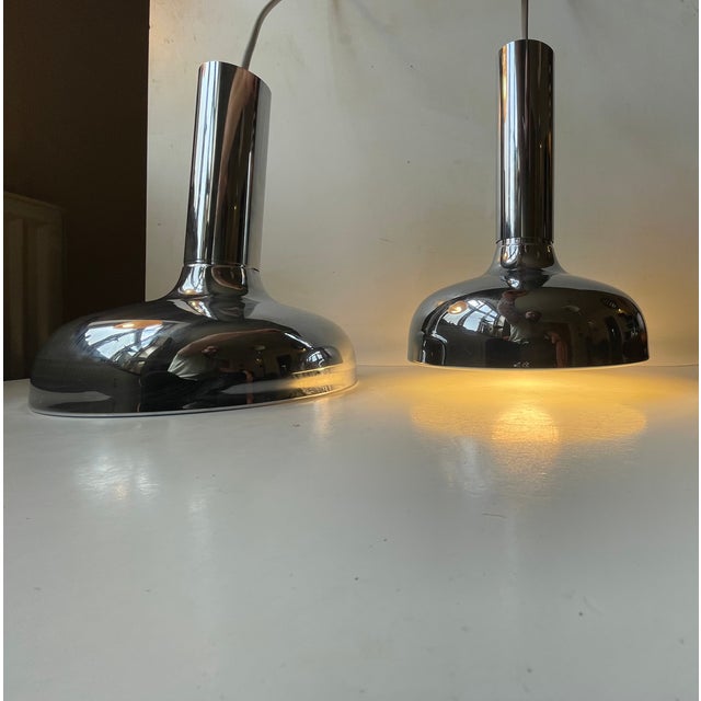A rare set of mirror chrome-plated hanging pendant lights designed by frank bentler for his own company bentler belysning...