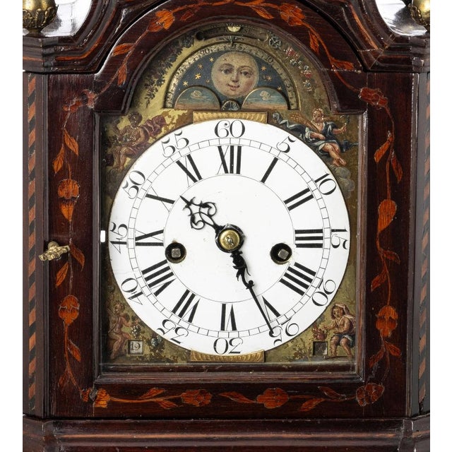 Table clock dutch, around 1740 with mahogany wood case with bronze applications, satinwood inlaid representing vegetal and...