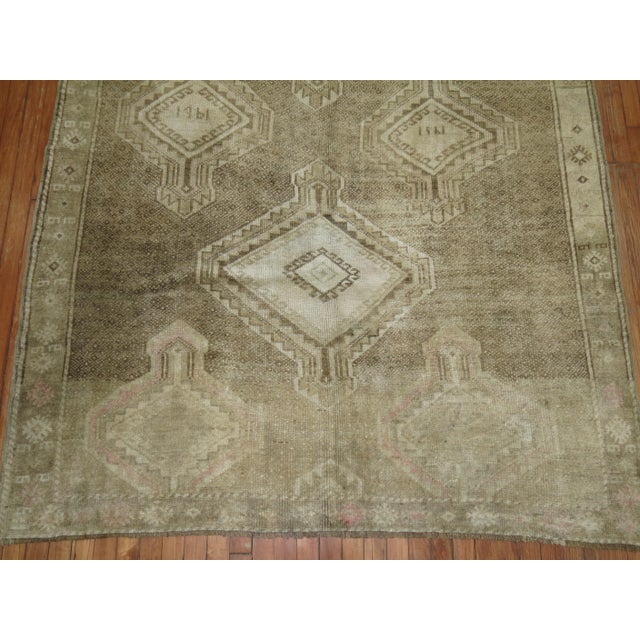 A Turkish Kars runner with a large scale geometric tribal medallion design throughout. There is some faded pink tones on 1...