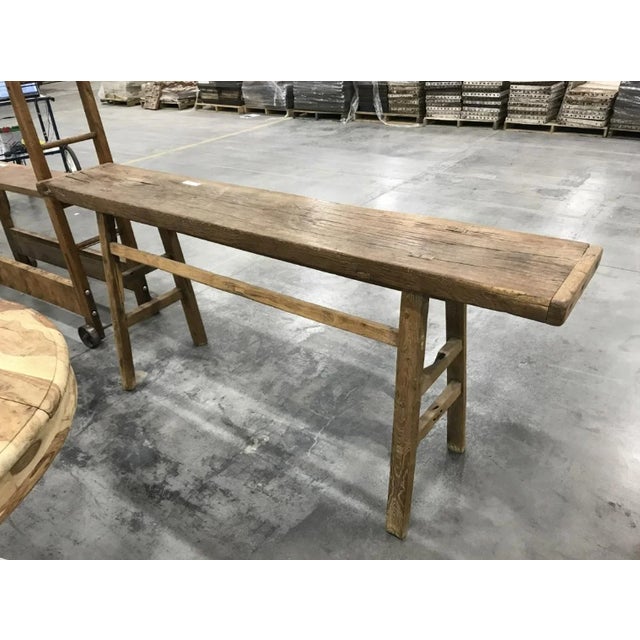 A substantial antique primitive wood mortise workbench with a beautifully worn surface and rich, layered patina developed...