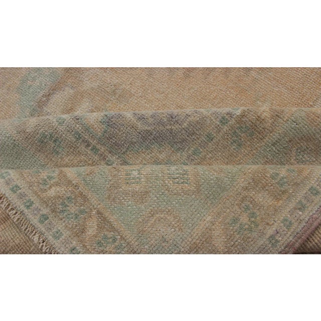 Faded Turkish Hand Knotted Oushak With Medallion With Muted Colors of Tan, Muted Light Peach For Sale - Image 11 of 13