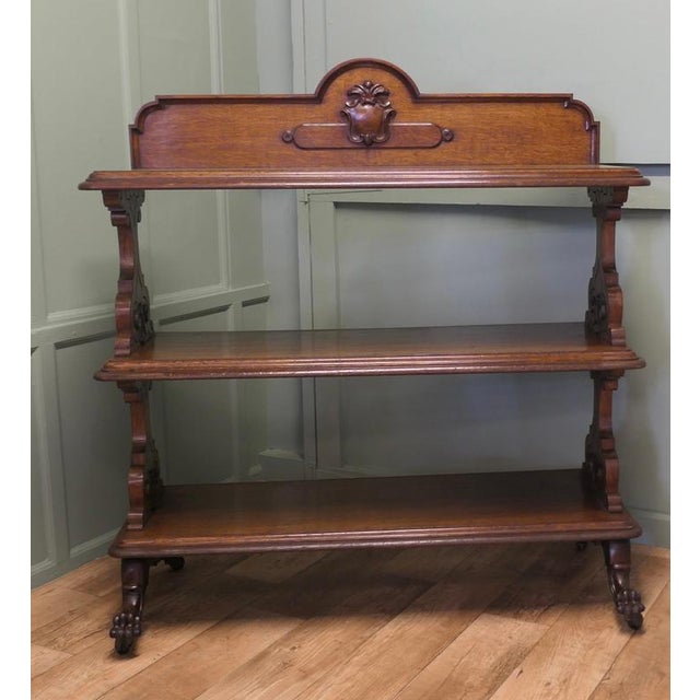 A Large Late Victorian Carved Oak buffet. The buffet has three deep tiers, supported on chunky pierced carved supports,...