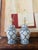 A striking pair of blue and white ginger jar lamps featuring a bold geometric lattice pattern paired with a classic Greek...