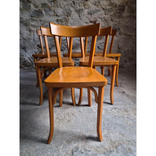 Set of six French bistro chairs made by Baumann in the 1950s. The chairs are made from beechwood and feature gently curved...