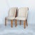 A pair of walnut backed cloud chairs by harry and lou epstein. Burr walnut veneers, upholstered in cream leather....