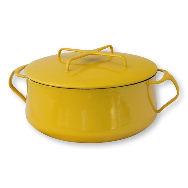 Dansk Kobenstyle yellow enamel pot with lid, featuring a rounded midcentury form and integrated side handles. Designed...