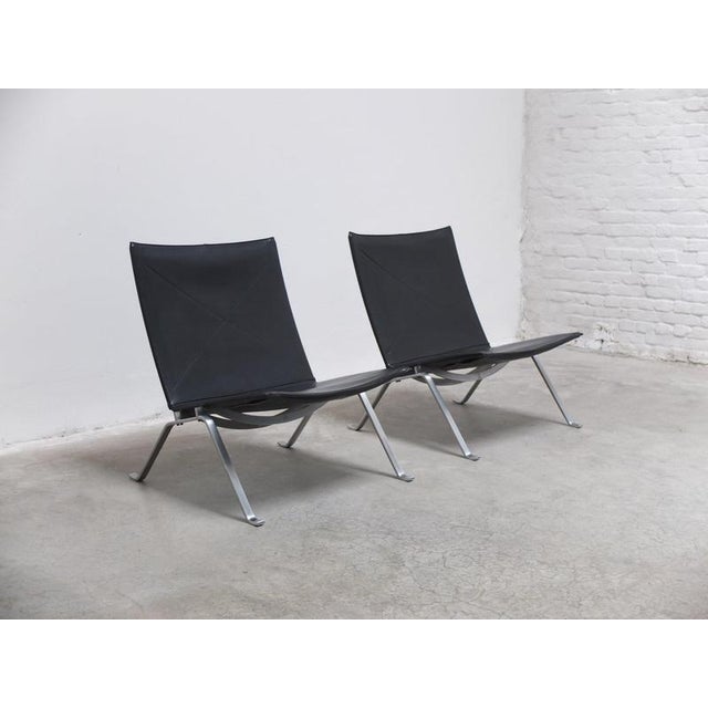 Wonderful pair of ‘PK22’ easy chairs designed by Poul Kjærholm in 1956. This is a beautiful black leather edition produced...