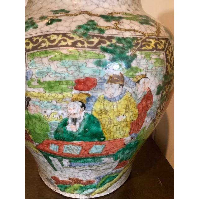 A beautiful antique ceramic vase with an all-over ice crackle glaze and wonderful hand painted scenes of scholars on the...