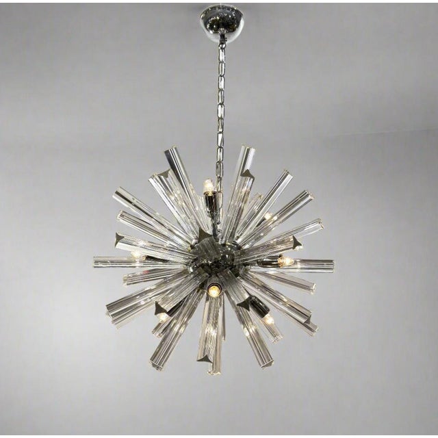 A stunning Venini Murano "Sputnik" chandelier featuring a polished chrome center sphere with radiating triangular cut...