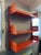 Beautiful shelving unit in shades of red and orange. In very good overall condition, with some minor signs of wear....