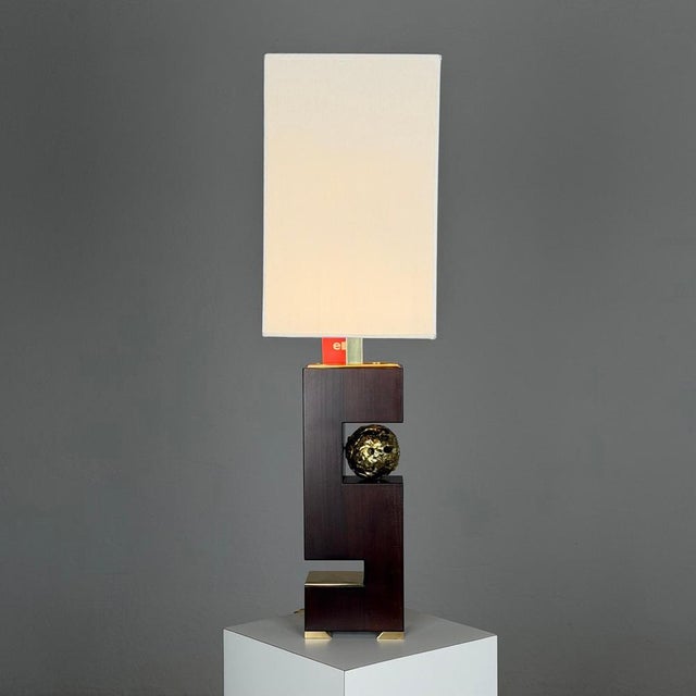 An imposing and architecturally composed table lamp model “hermes,” designed by angelo brotto for esperia in the 1970s....