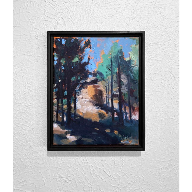 This oil on canvas work captures a serene landscape, where tall trees frame a softly illuminated clearing. The vibrant...