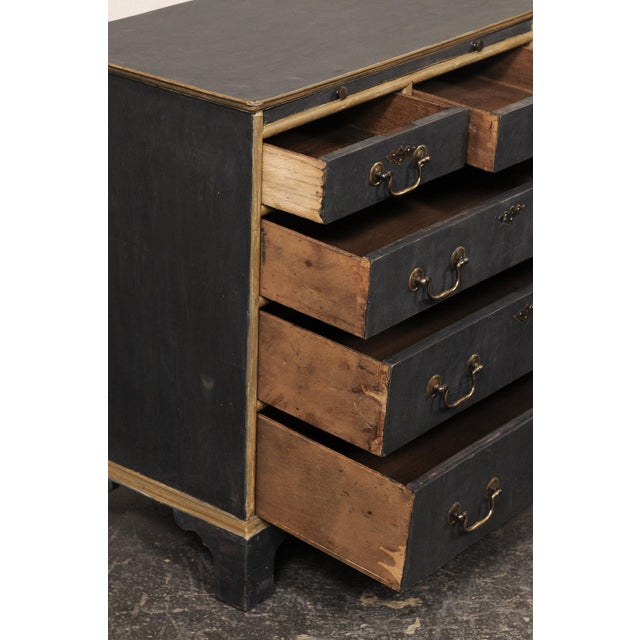 An English pair of petite five-drawer painted wood sides chests from the mid 20th century. This mid-century pair of...