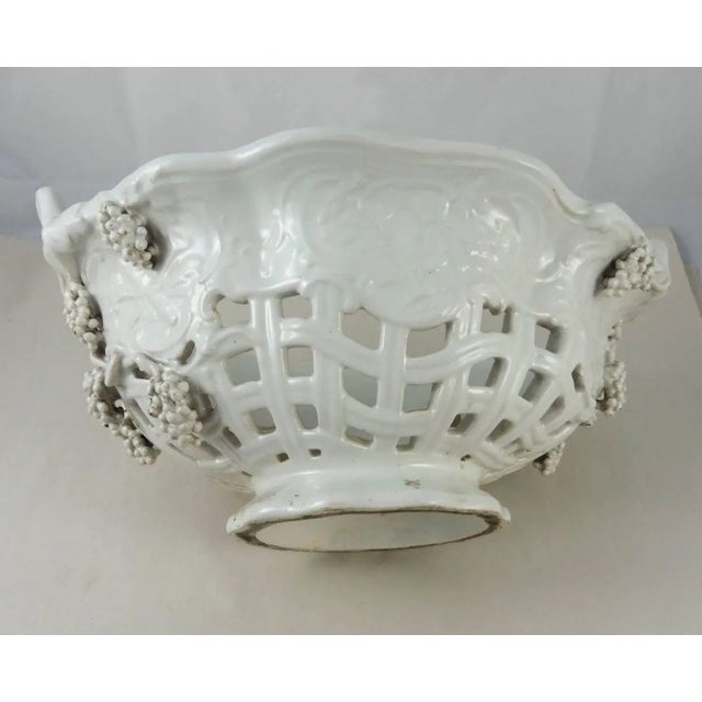 French white faience grapes-motif reticulated handled basket, circa 1900.