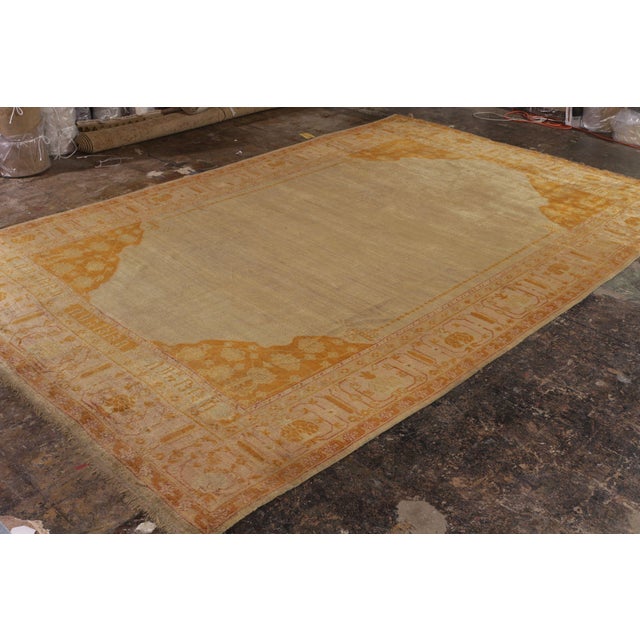 Hand-knotted in Turkey originating between 1870-1880, this antique Oushak rug enjoys a subtle, luminous sheen to its...