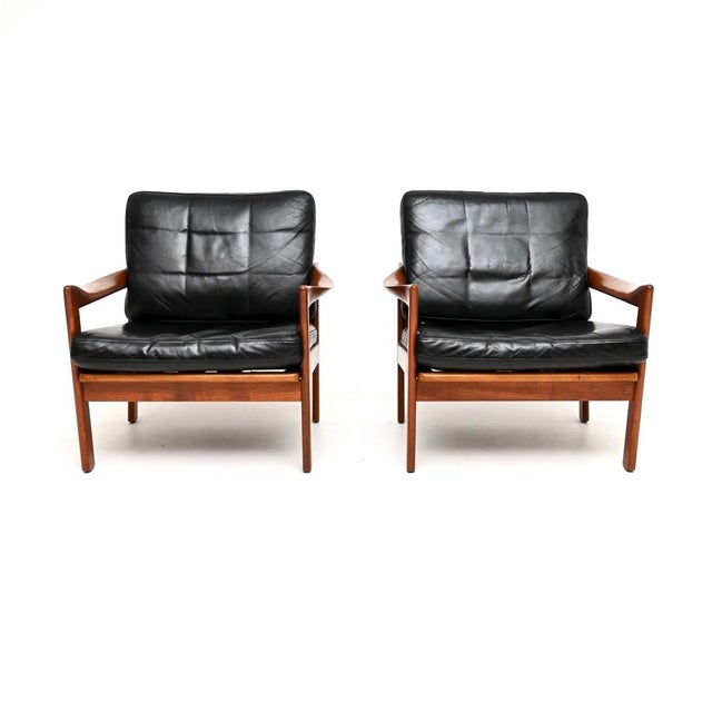 A stunning pair of Danish teak and leather armchairs by Illum Wikkelso. They were made in Denmark in the 1960’s. The...