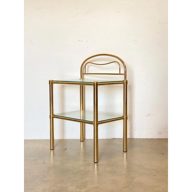 Pair of 80s bedside tables, brass structure and glass tops, height on the 52cm floor.