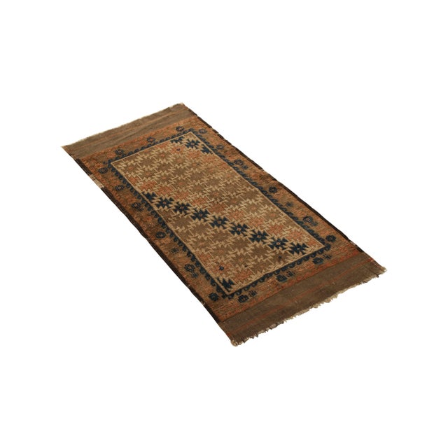 Hand knotted in wool originating circa 1890-1900, this 1x2 antique rug denotes a rare Baluch rug design in both an...