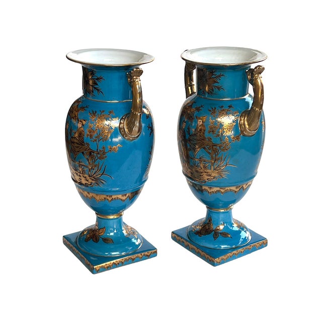 a large and elegant pair of Louis XVI Style urns with hand-painted gilt decoration depicting Chinese figures in a tranquil...