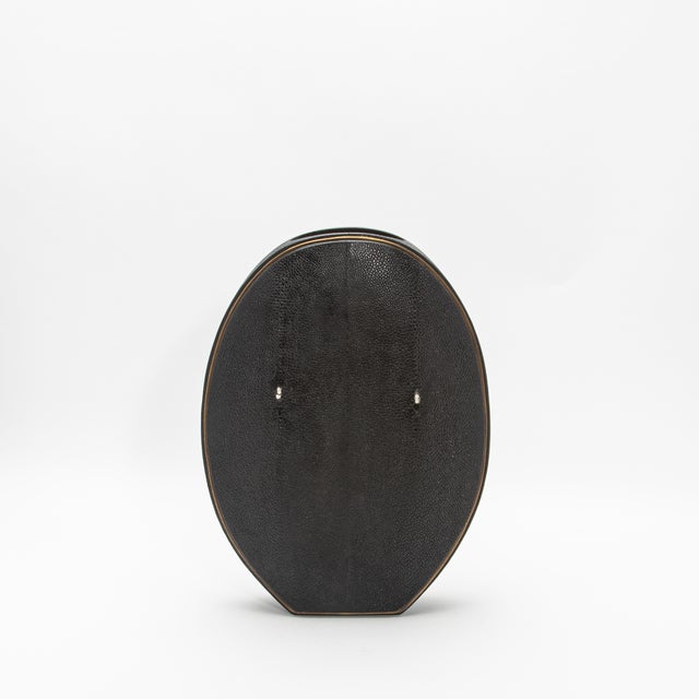 The elegant "Oval Vase" by R&Y Augousti, crafted in shagreen and accented with brass, is a sophisticated fusion of organic...